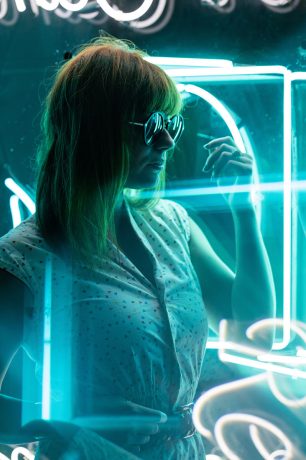 cinematic-portrait-of-girl-with-sunglasses-on-neon-UMXW8QN